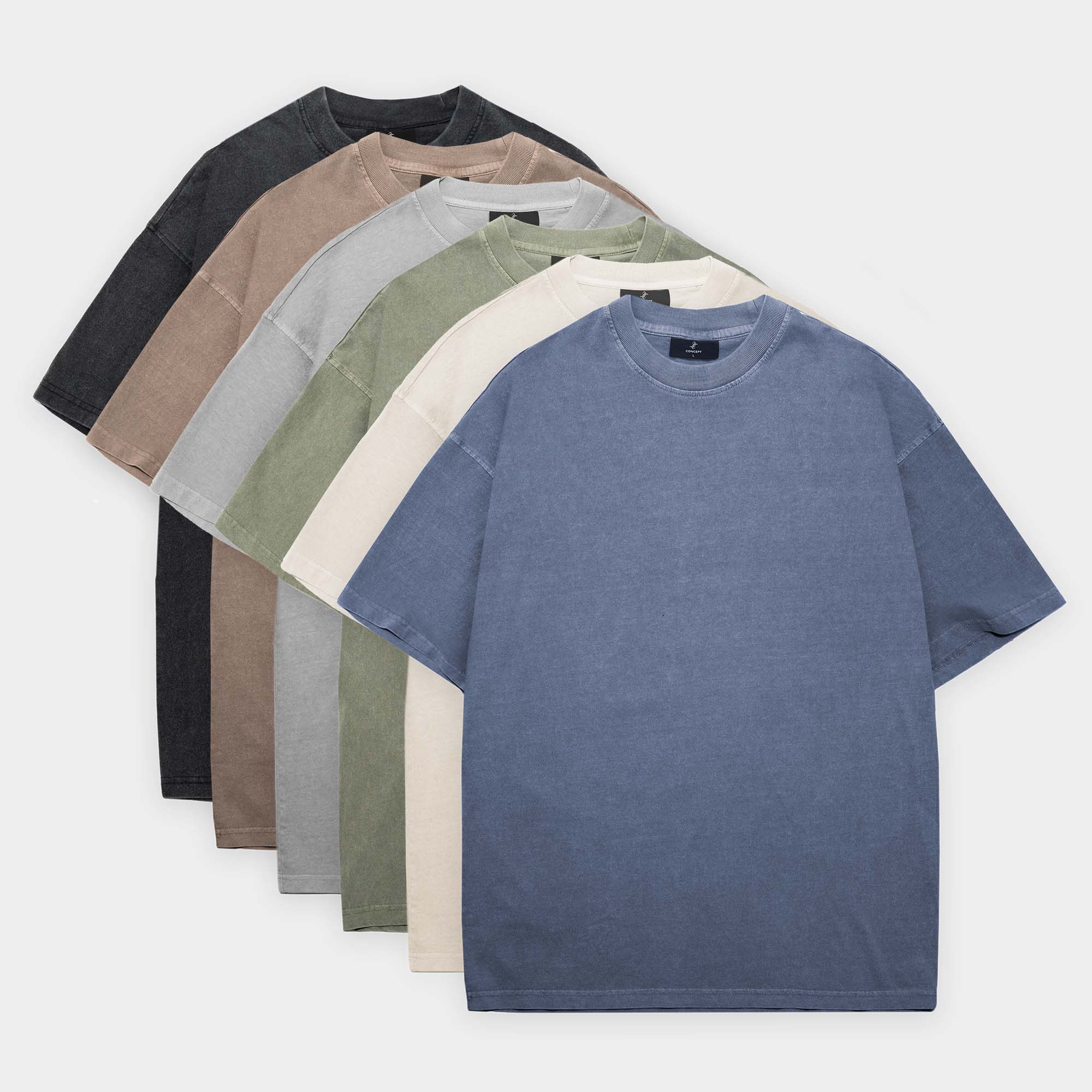 Set of six plain t-shirts in different colors arranged on a white background